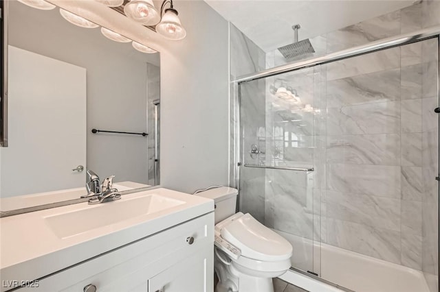 bathroom with toilet, a stall shower, and vanity