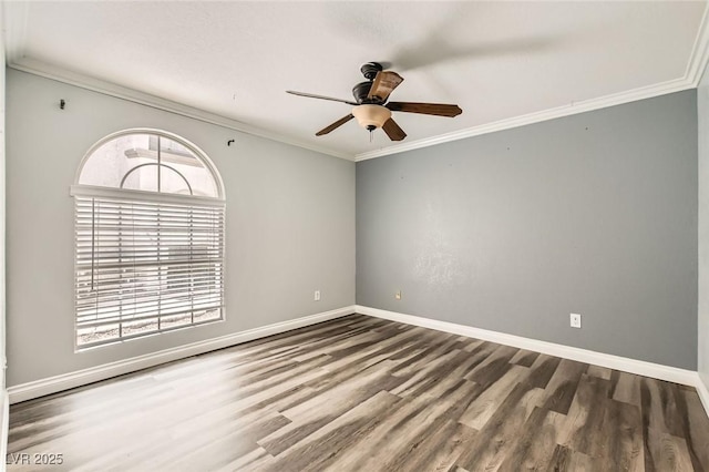 spare room featuring healthy amount of natural light, wood finished floors, a ceiling fan, ornamental molding, and baseboards