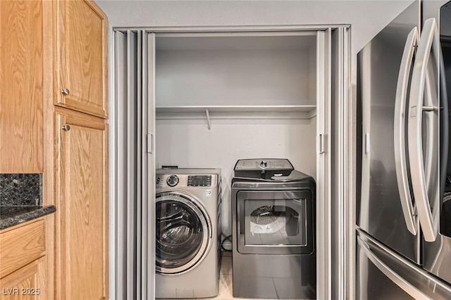 clothes washing area with independent washer and dryer