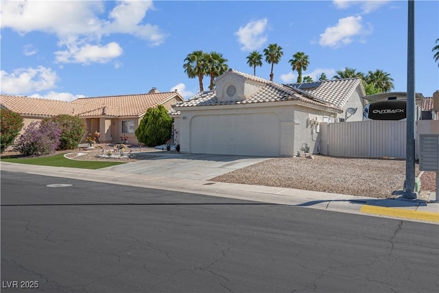 4644 Canna Dr, Las Vegas, NV 89122 - view of front of home with an attached garage, stucco siding, driveway, a tiled roof, and fence