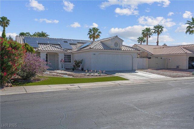 4644 Canna Dr, Las Vegas, NV 89122 - view of front of property with an attached garage, a tiled roof, driveway, stucco siding, and fence
