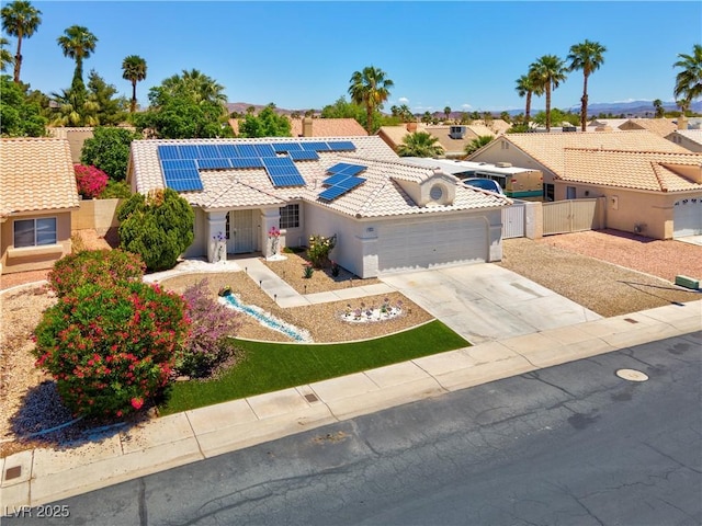 4644 Canna Dr, Las Vegas, NV 89122 - view of front of property with a tile roof, stucco siding, solar panels, a garage, and a gate