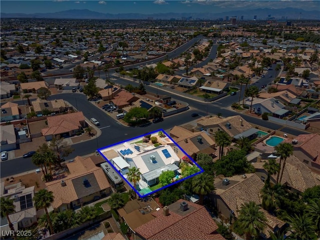 4644 Canna Dr, Las Vegas, NV 89122 - aerial perspective of suburban area featuring property boundaries highlighted, a mountainous background, and a pool area