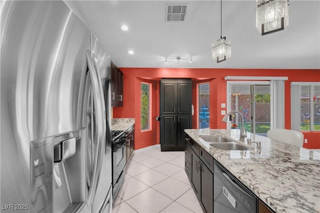 4644 Canna Dr, Las Vegas, NV 89122 - kitchen with black appliances, a sink, healthy amount of natural light, light stone counters, and recessed lighting