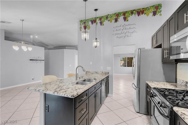 4644 Canna Dr, Las Vegas, NV 89122 - kitchen with a sink, light tile patterned flooring, black gas stove, a peninsula, and lofted ceiling