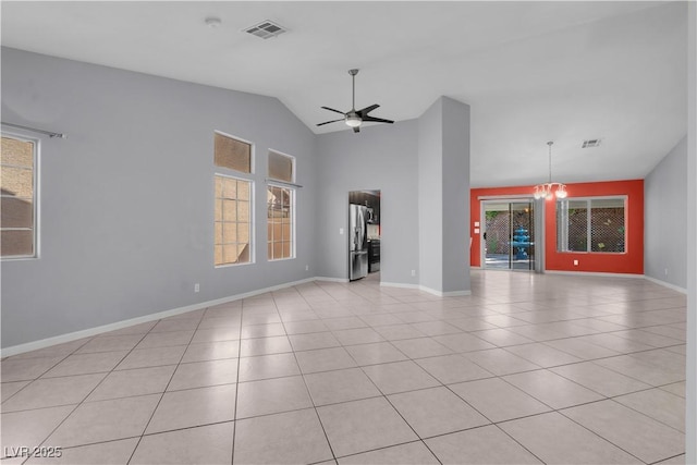 4644 Canna Dr, Las Vegas, NV 89122 - unfurnished living room featuring healthy amount of natural light, light tile patterned floors, a ceiling fan, and vaulted ceiling