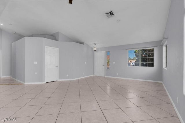 4644 Canna Dr, Las Vegas, NV 89122 - unfurnished living room with lofted ceiling, light tile patterned floors, and baseboards