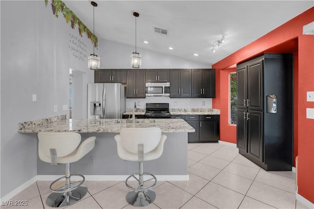 4644 Canna Dr, Las Vegas, NV 89122 - kitchen featuring appliances with stainless steel finishes, a sink, lofted ceiling, a peninsula, and a kitchen breakfast bar