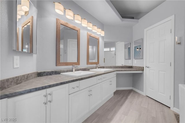 4644 Canna Dr, Las Vegas, NV 89122 - bathroom featuring wood finished floors, vanity, and baseboards