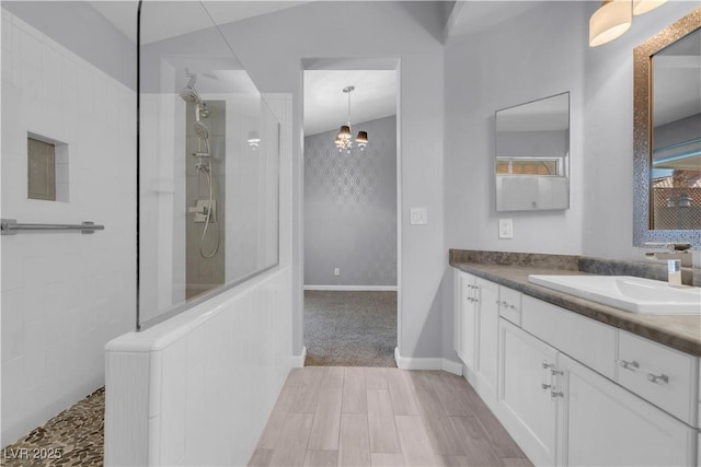 4644 Canna Dr, Las Vegas, NV 89122 - bathroom with a walk in shower, vanity, a chandelier, wood finished floors, and baseboards