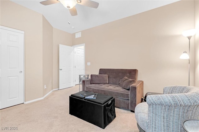 living area featuring light carpet, ceiling fan, and baseboards