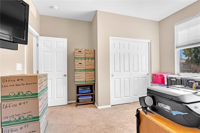 office area with light colored carpet and baseboards