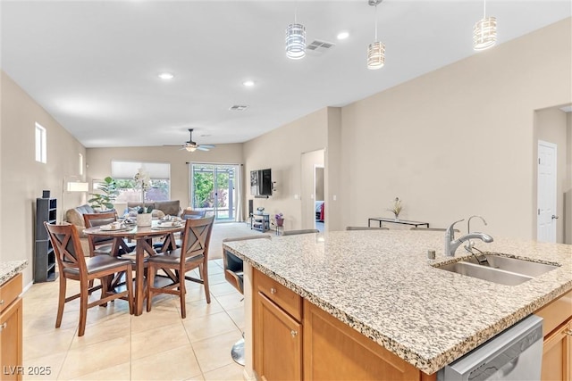kitchen featuring a sink, dishwasher, a ceiling fan, open floor plan, and light tile patterned floors