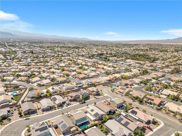 aerial view of residential area featuring a mountainous background