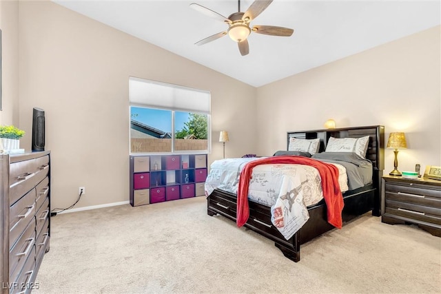 bedroom with lofted ceiling, carpet floors, baseboards, and a ceiling fan