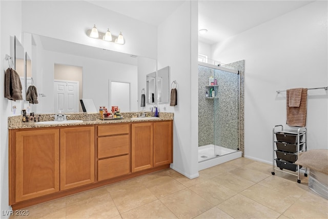 bathroom with a shower stall, double vanity, and tile patterned flooring