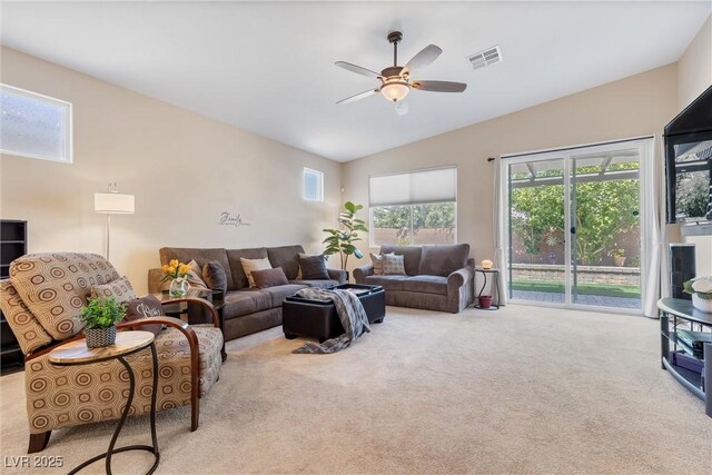 carpeted living area featuring lofted ceiling, ceiling fan, and plenty of natural light