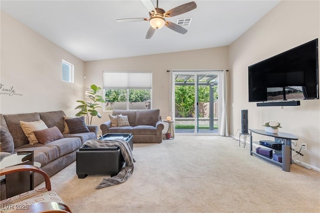 living room featuring carpet floors, ceiling fan, and vaulted ceiling
