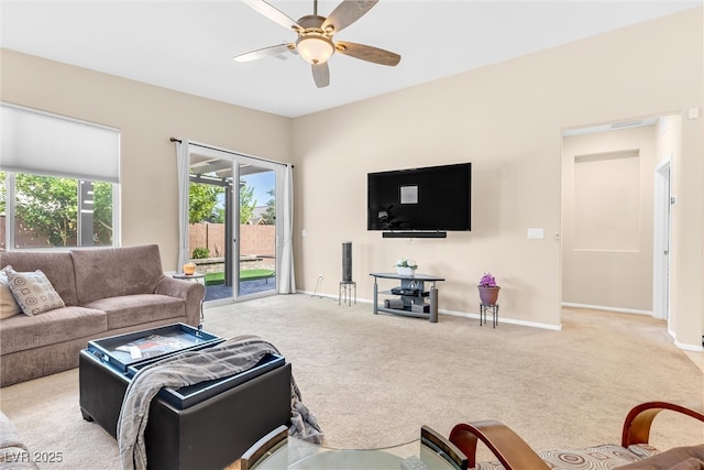 living room with a ceiling fan, carpet, and baseboards