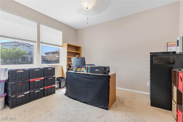 home office with carpet floors, baseboards, and a ceiling fan
