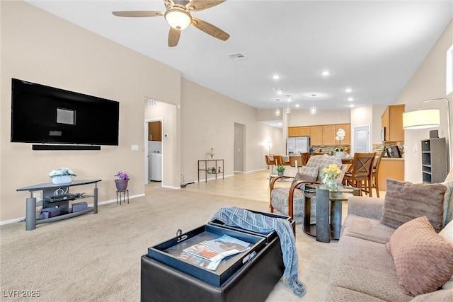 living room with a ceiling fan, light colored carpet, recessed lighting, and baseboards