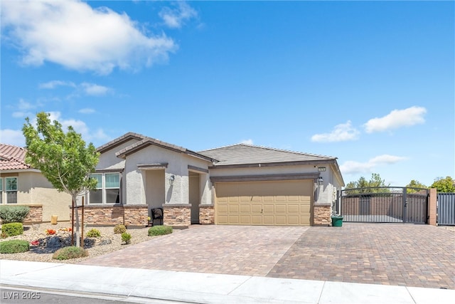 view of front facade with stone siding, decorative driveway, a gate, a garage, and stucco siding