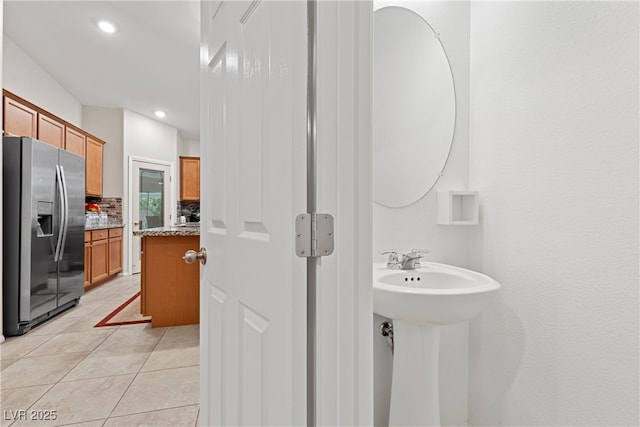 7070 Cinder Horse St, Las Vegas, NV 89131 - bathroom featuring tasteful backsplash, tile patterned flooring, recessed lighting, and a sink