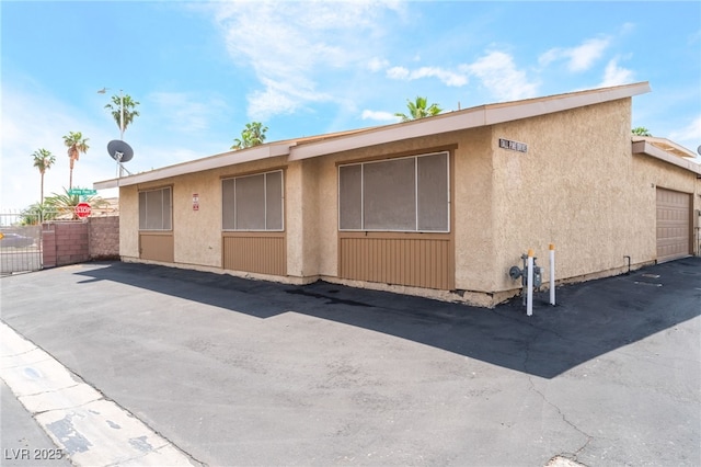 2261 Tall Pine Dr, Las Vegas, NV 89108 - view of property exterior featuring fence and stucco siding