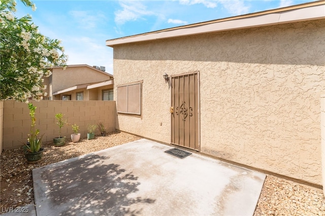 2261 Tall Pine Dr, Las Vegas, NV 89108 - view of exterior entry with fence, stucco siding, and a patio