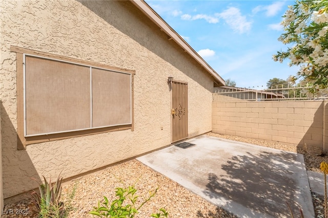 2261 Tall Pine Dr, Las Vegas, NV 89108 - view of side of home featuring a patio area, fence, and stucco siding