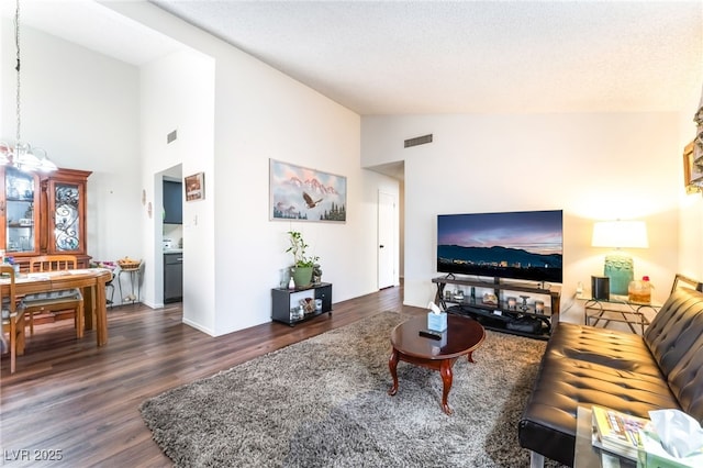 2261 Tall Pine Dr, Las Vegas, NV 89108 - living area featuring dark wood-style floors and high vaulted ceiling
