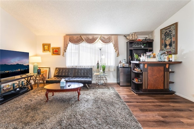 2261 Tall Pine Dr, Las Vegas, NV 89108 - living room featuring wood finished floors, a textured ceiling, and a bar