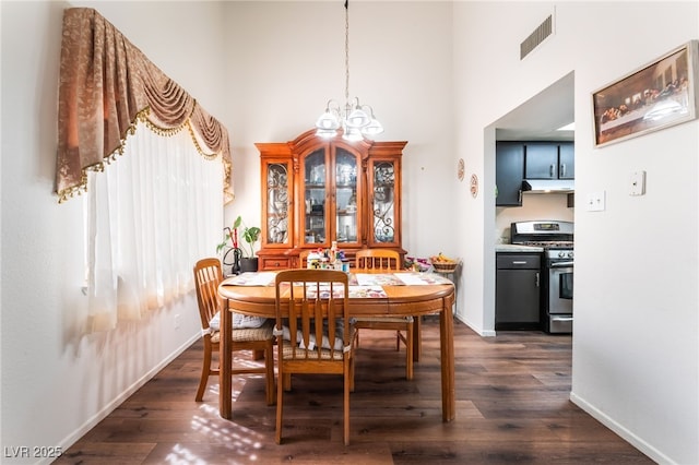 2261 Tall Pine Dr, Las Vegas, NV 89108 - dining area featuring a high ceiling, dark wood-type flooring, baseboards, and a chandelier