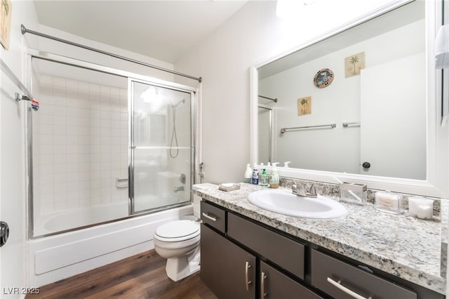 2261 Tall Pine Dr, Las Vegas, NV 89108 - bathroom featuring wood finished floors, vanity, toilet, and enclosed tub / shower combo