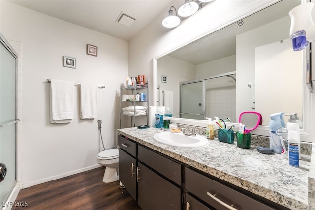 2261 Tall Pine Dr, Las Vegas, NV 89108 - full bath featuring a shower stall, wood finished floors, vanity, toilet, and baseboards