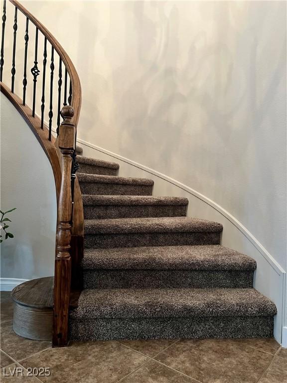 stairway with tile patterned flooring