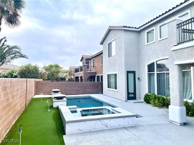 view of swimming pool with a fenced backyard, a patio, and a pool with connected hot tub