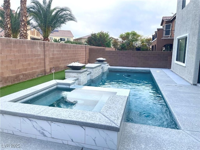 view of swimming pool featuring a fenced backyard and a pool with connected hot tub