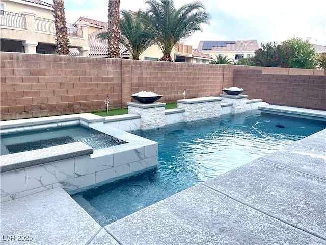 view of swimming pool featuring a fenced backyard and a pool with connected hot tub
