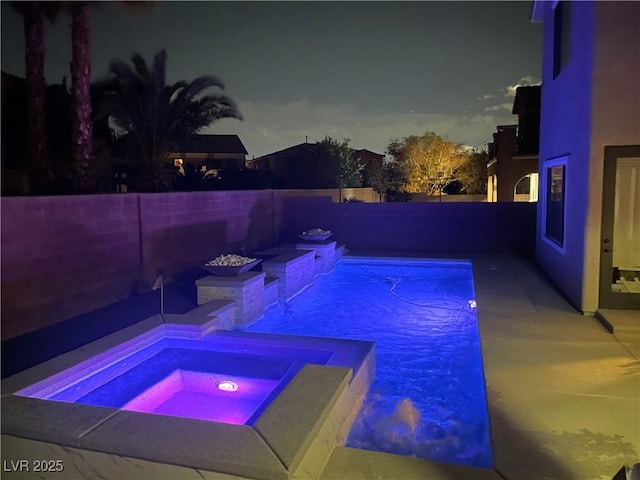 view of swimming pool with an in-ground hot tub and a fenced backyard