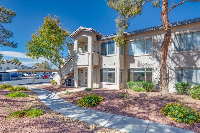 5217 Caspian Springs Dr Unit 101, Las Vegas, NV 89120 - view of front of home featuring stairs, stucco siding, and a tiled roof