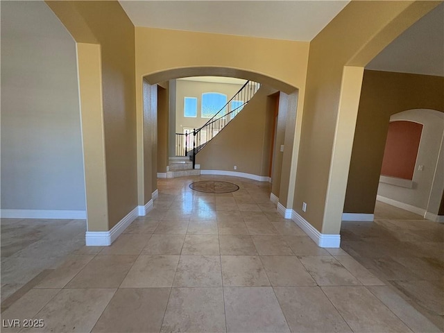 357 Whispering Tree Ave, Las Vegas, NV 89183 - foyer entrance with arched walkways, baseboards, and light tile patterned floors