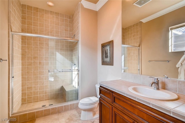 bathroom featuring ornamental molding, a shower stall, toilet, vanity, and tile patterned flooring
