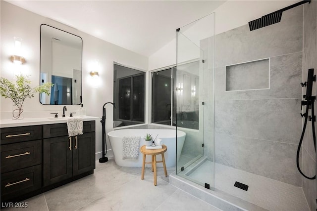 full bathroom with a stall shower, vanity, and a soaking tub