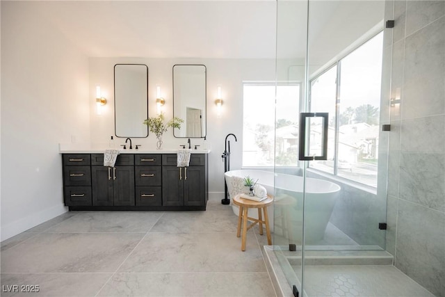 bathroom with double vanity, a freestanding tub, baseboards, and a shower stall