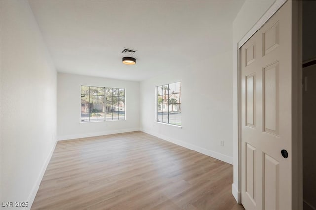 unfurnished room featuring light wood-style floors and baseboards