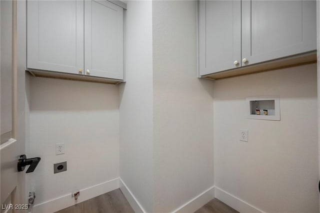 laundry area with electric dryer hookup, cabinet space, wood finished floors, baseboards, and hookup for a washing machine