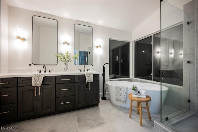 full bath with a freestanding tub and double vanity