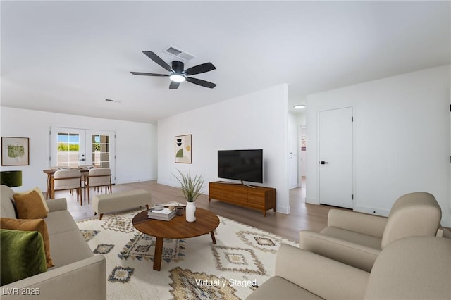 living room with french doors, wood finished floors, ceiling fan, and baseboards