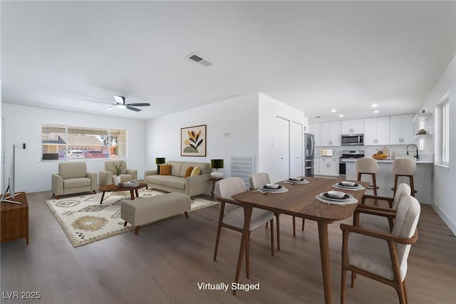 dining area featuring wood finished floors, ceiling fan, and recessed lighting